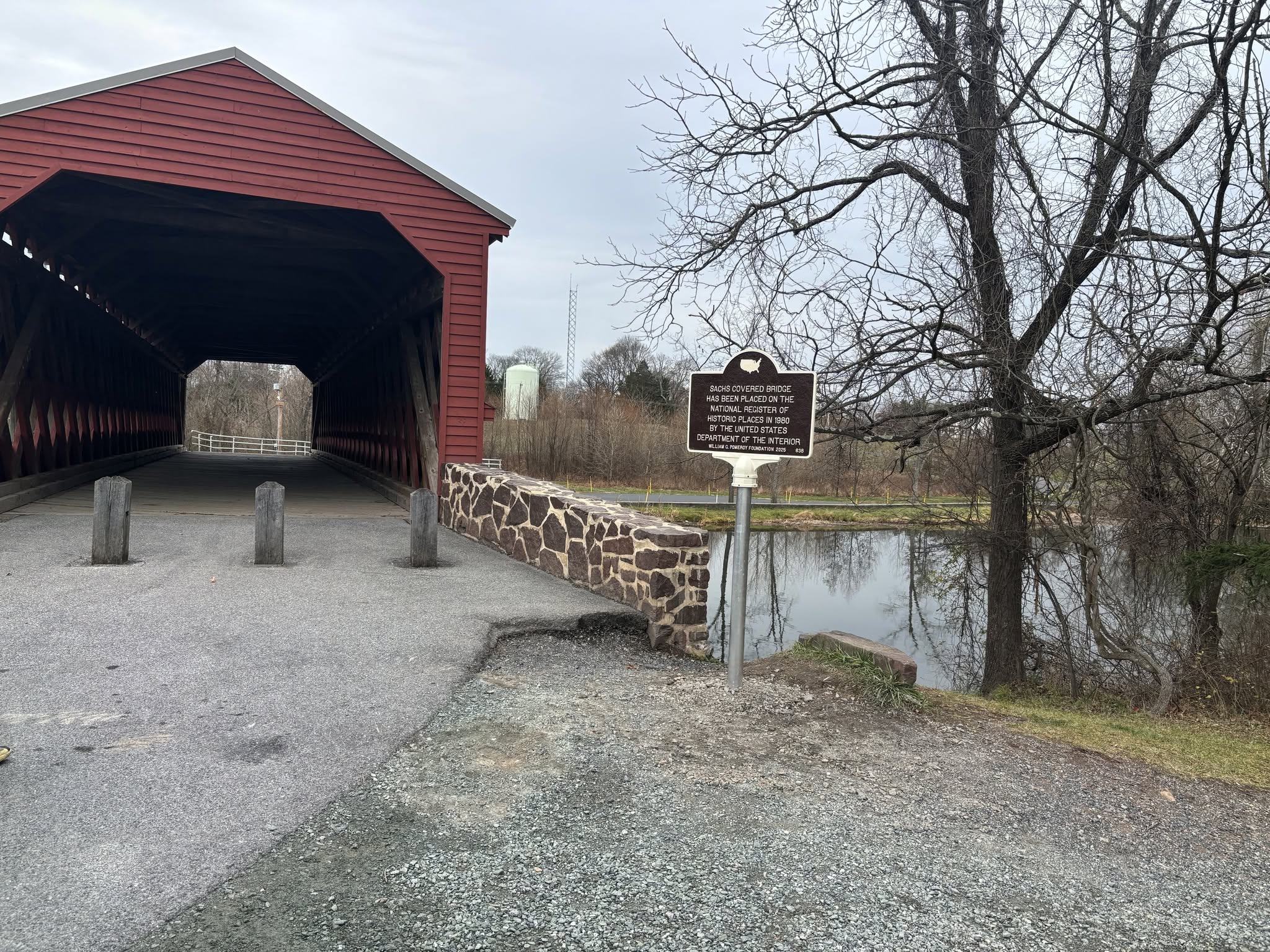 Sachs Covered Bridge with the Pomeroy Foundation historic marker visible beside the entrance, Adams County, Pennsylvania